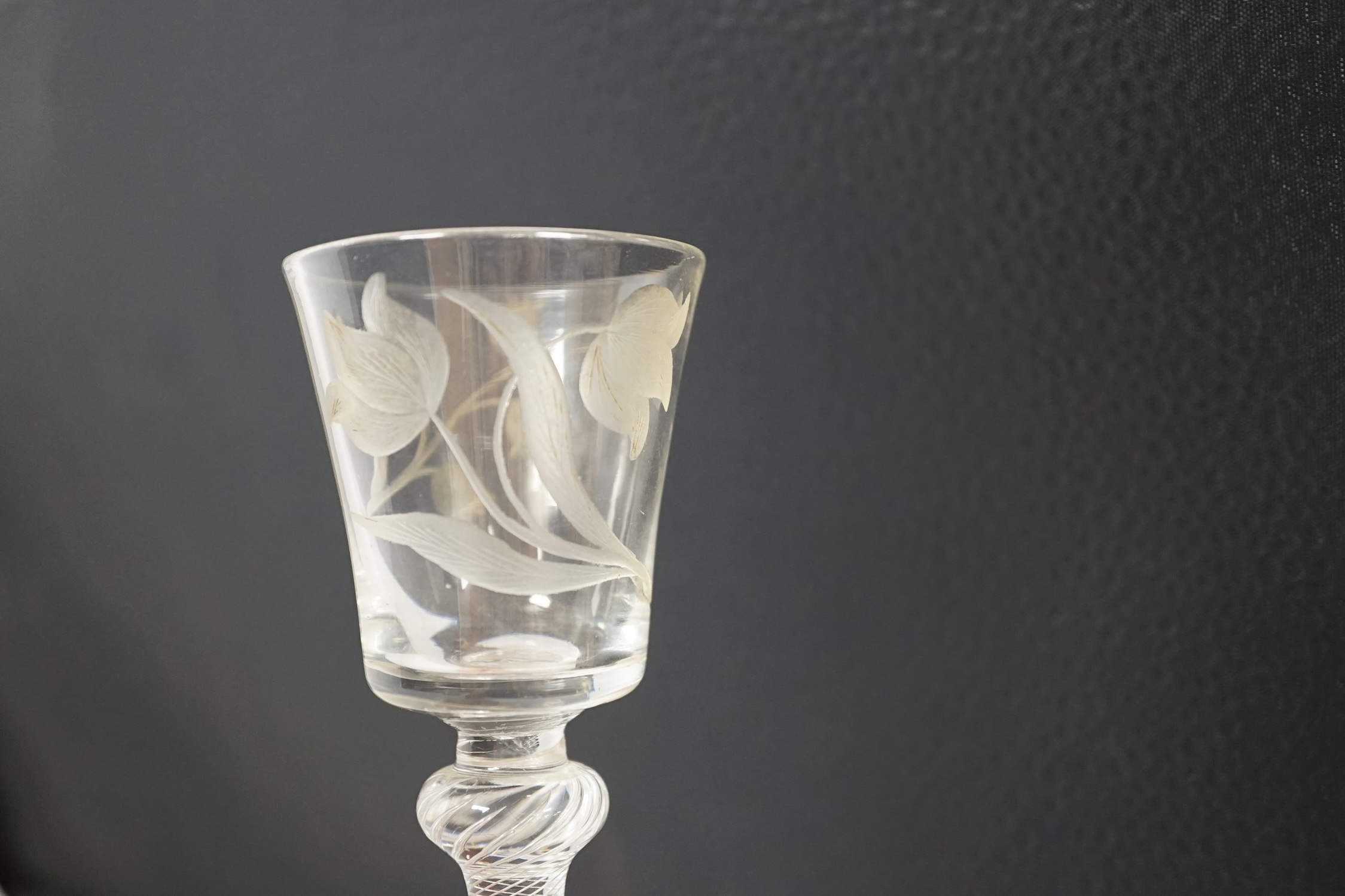 A mid 18th century air twist stem cordial glass with later engraved decoration, 15.5cm high. Condition - fair
